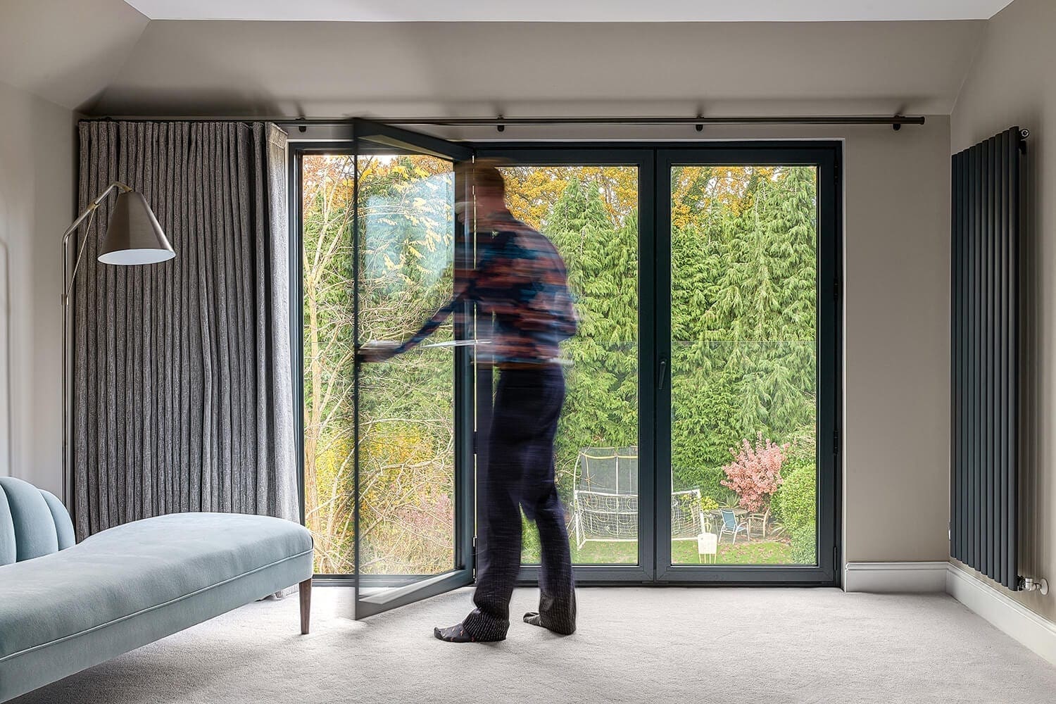 man opening doors of loft conversion on to juliet balcony