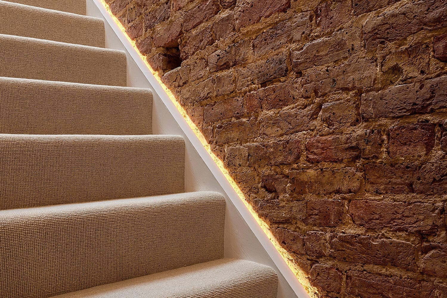 loft staircase lined with golden led strip lights