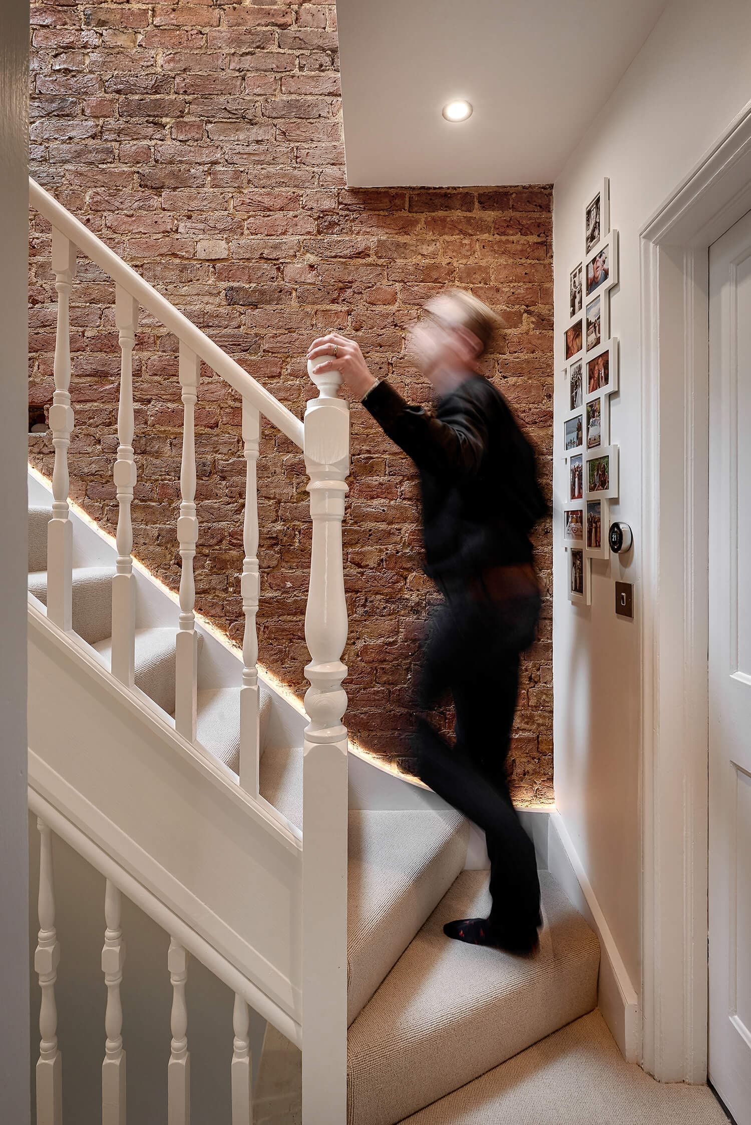 client walking up loft staircase to enjoy their new l-shaped loft space