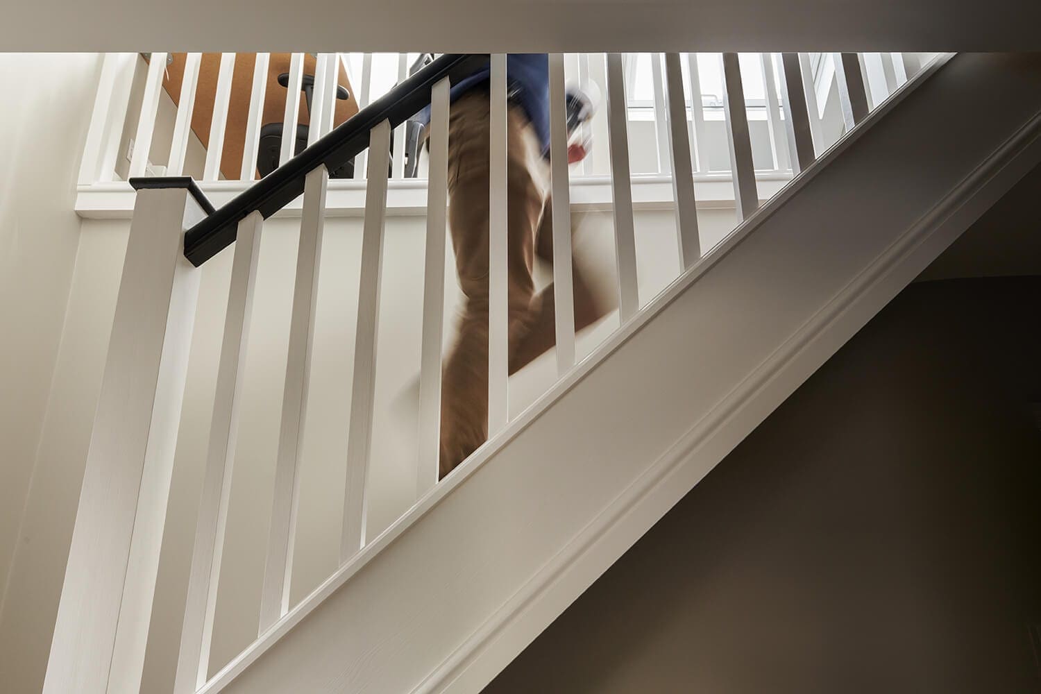 man walking up staircase into loft conversion