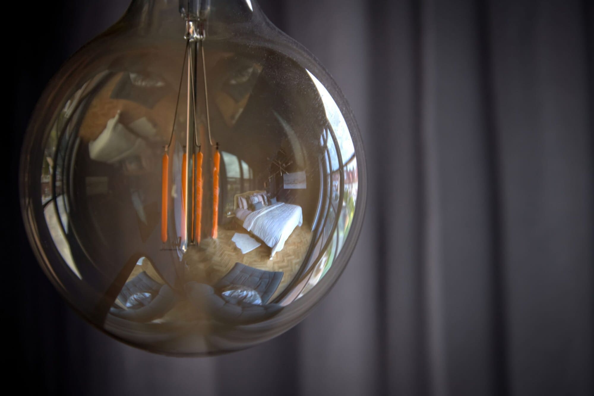 filament bulb in surface reflection shows high-end loft conversion