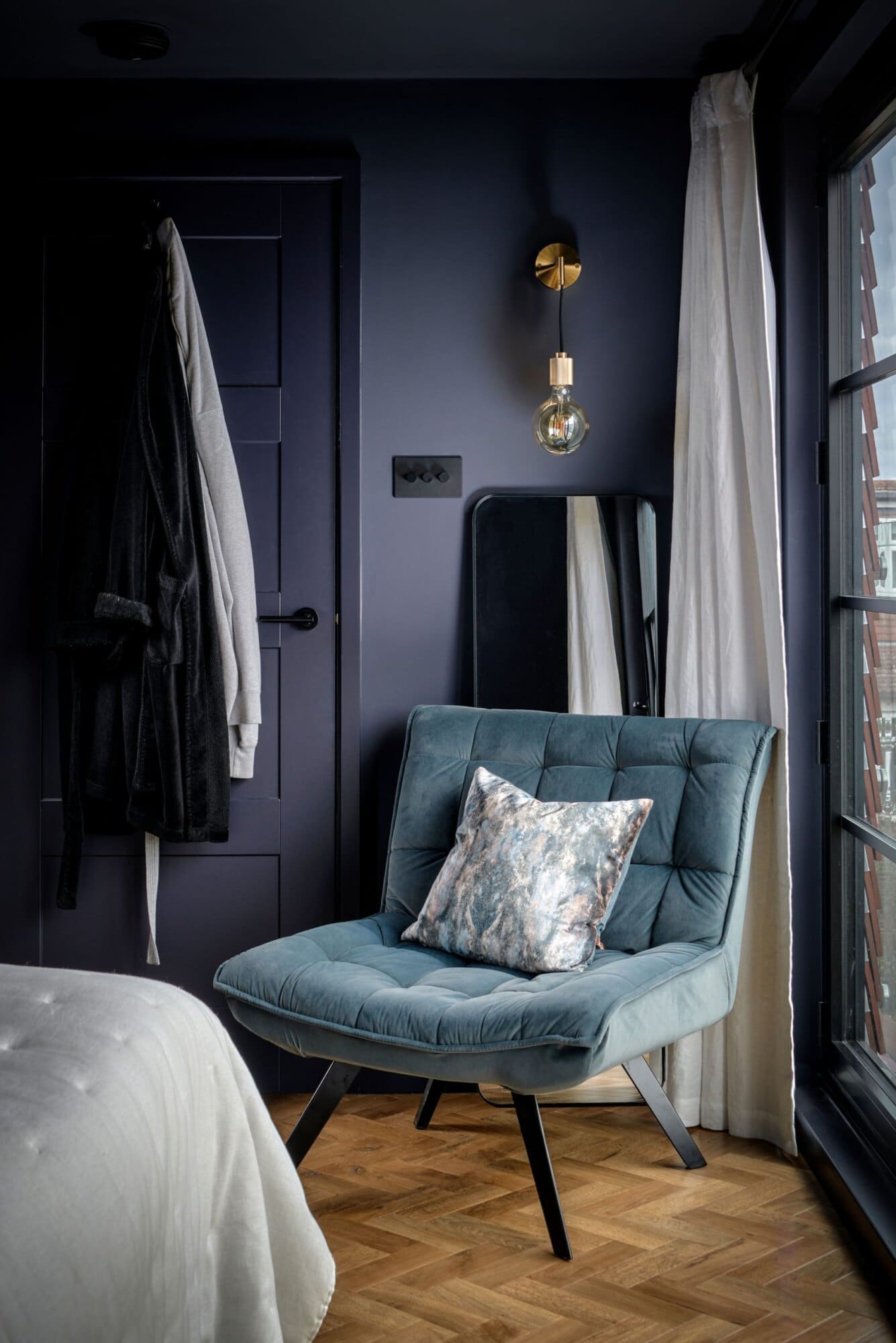 navy chair in corner of bedroom loft conversion