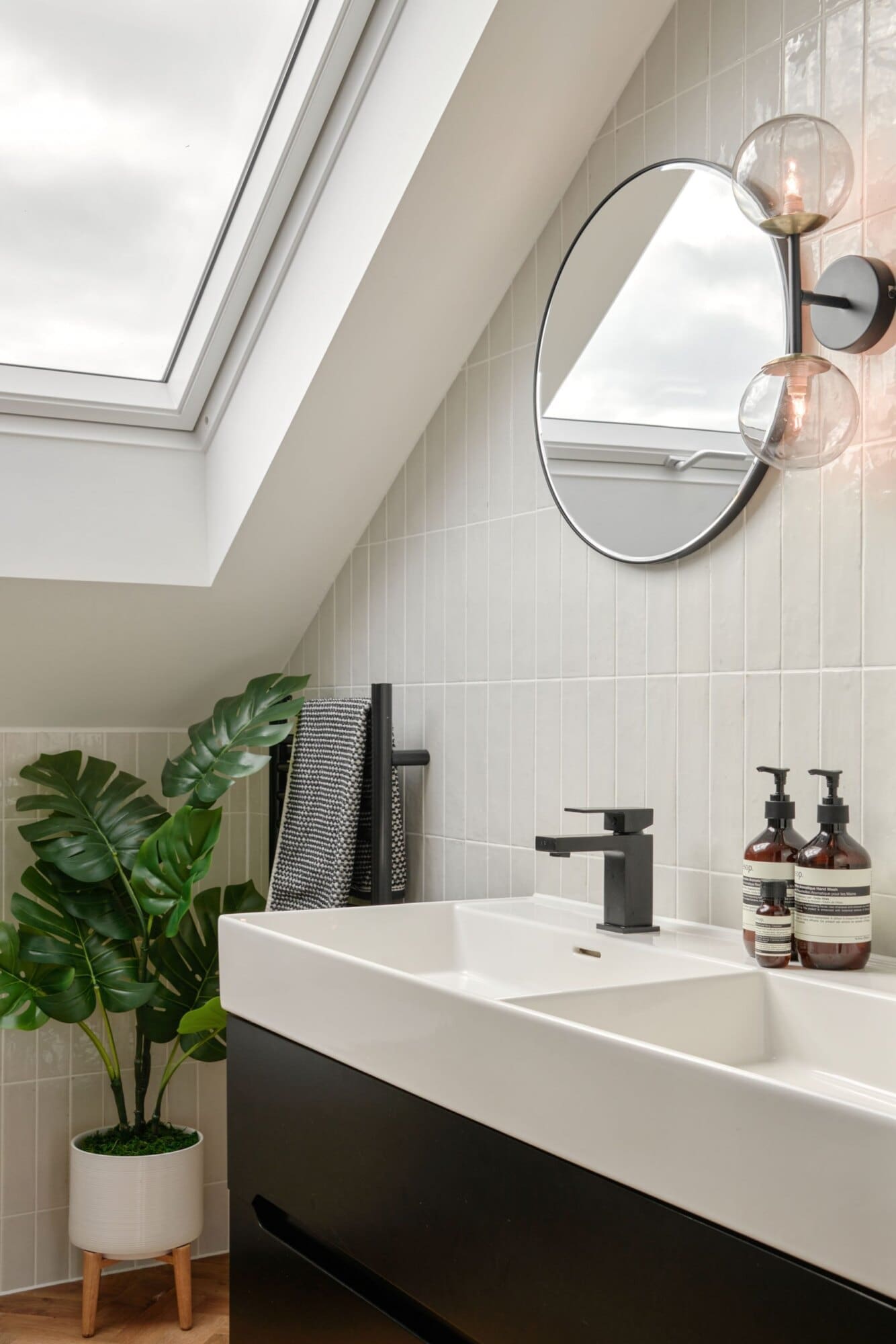 bright pitched roof windows illuminate modern white sink