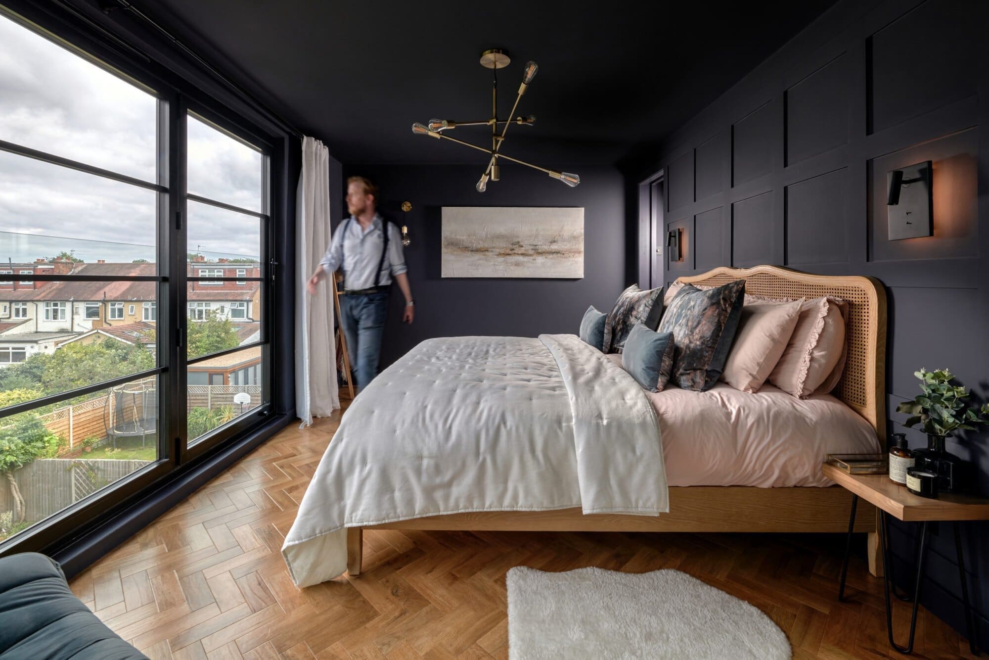 dark styled loft conversion bedroom with bi-fold windows