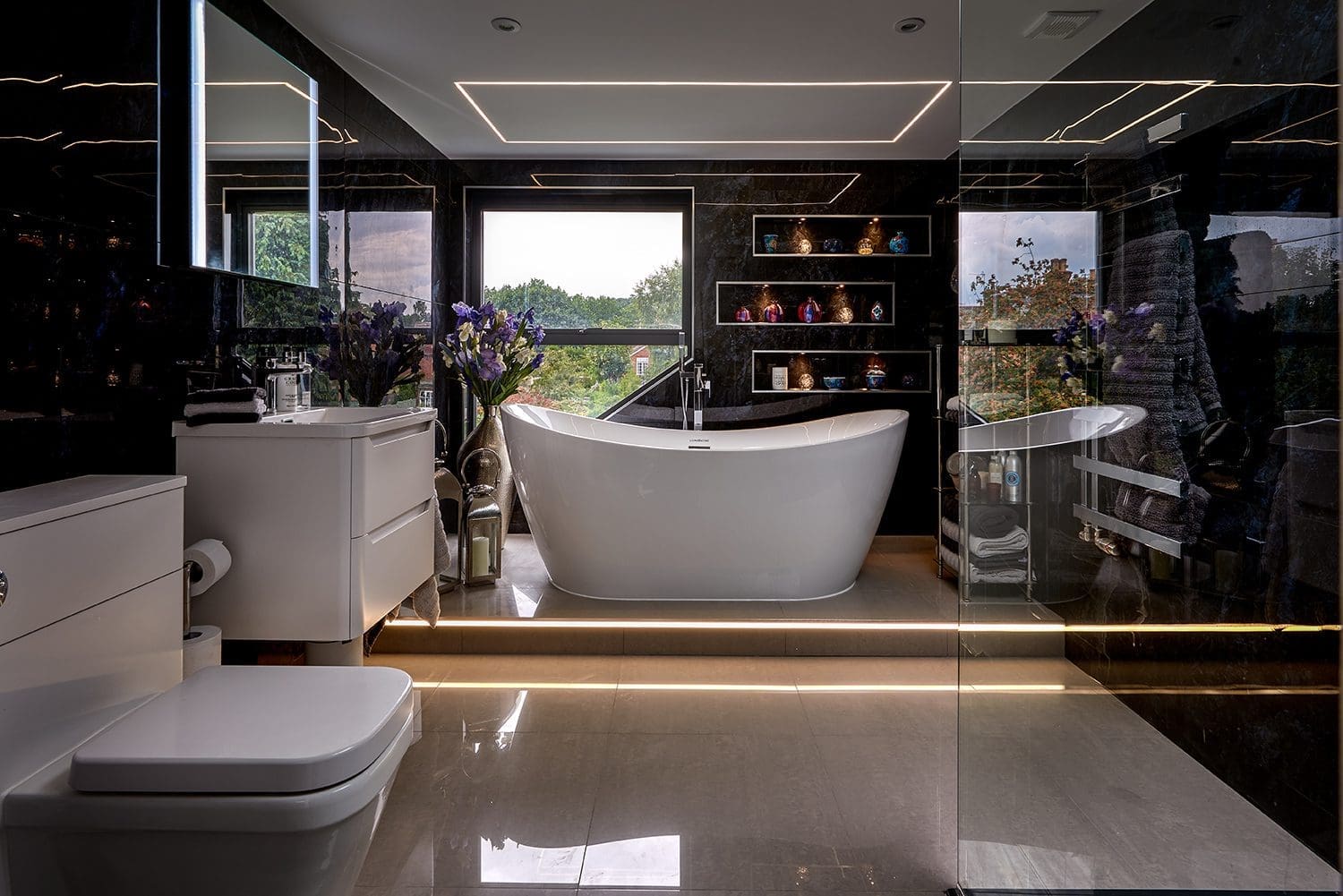 dark luxury bathroom featuring a freestanding bath in a renovated victorian loft