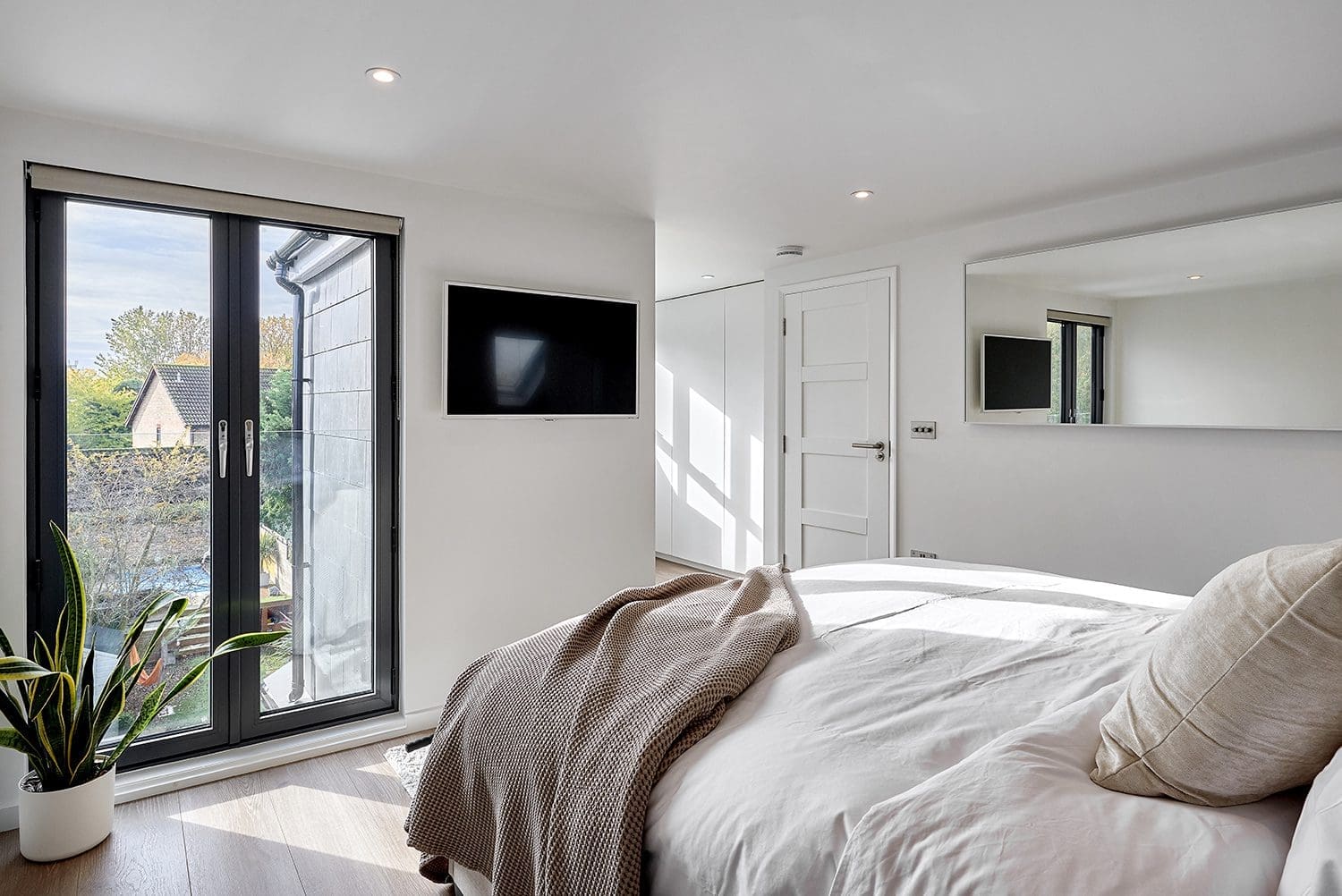 move vs loft conversion - minimalist loft conversion master bedroom with glass doors