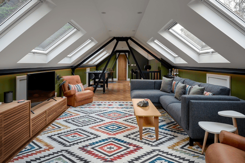 multi-use loft conversion with lounge and games area in modern boho style