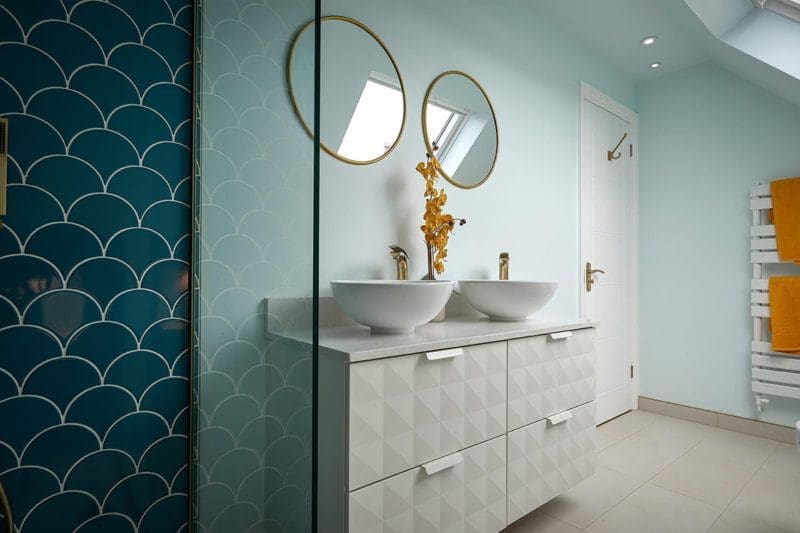 blue tiled bathroom and textured cabinets in hip to gable loft conversion
