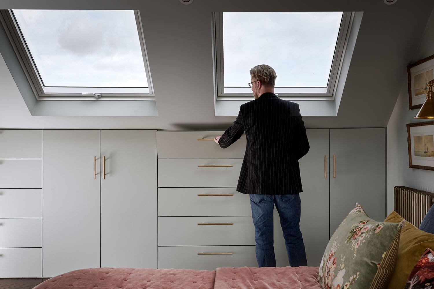 Planning for a Loft Conversion in a Conservation Area - man opening storage in loft conversion