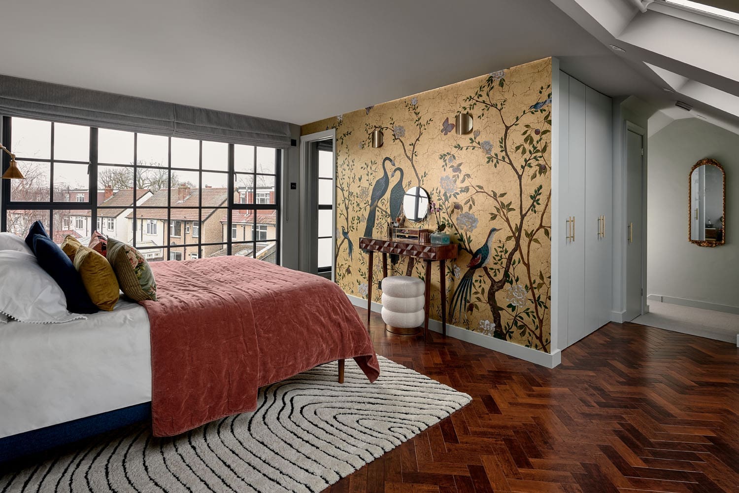 rear dormer loft conversion bedroom with gold decorative wallpaper and full length velux windows