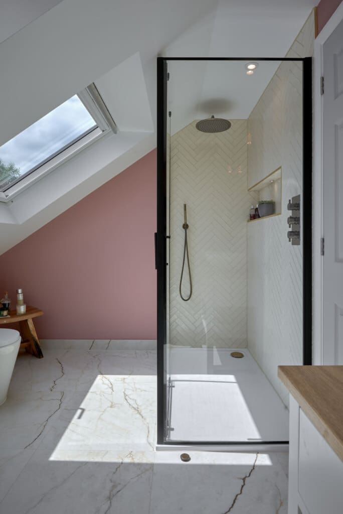 rear dorner loft bathroom walk-in shower with skylight windows illuminating marble tiling