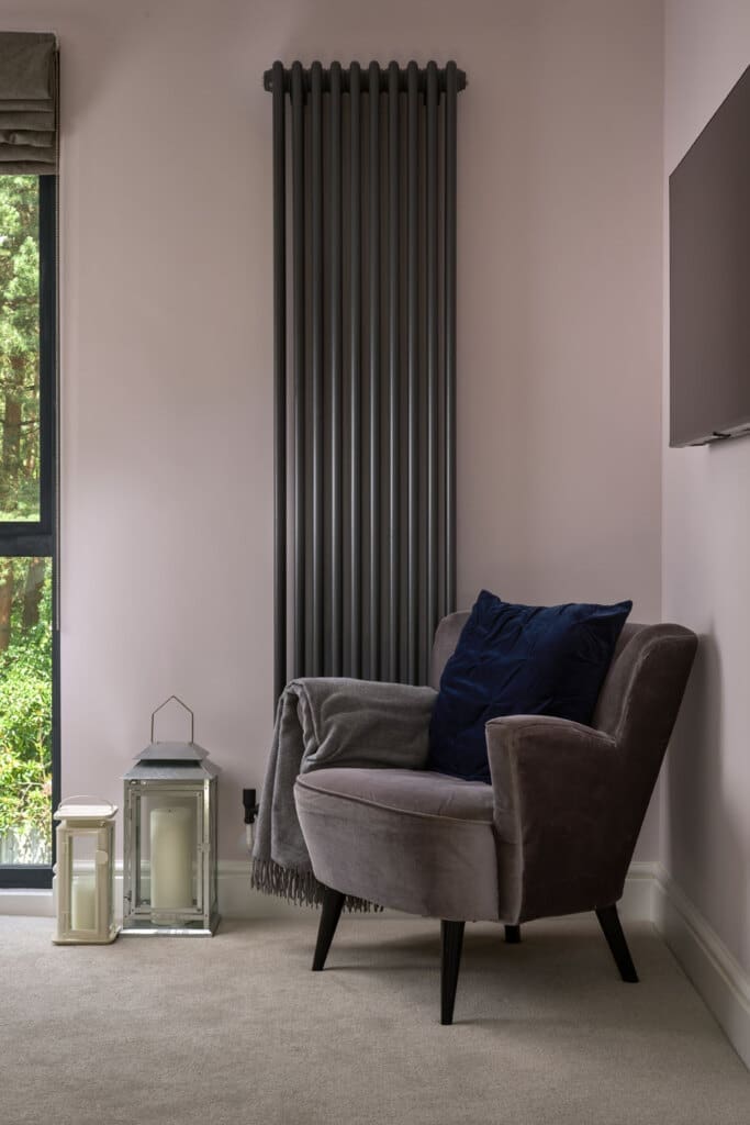 open plan loft with arm chair and long radiator