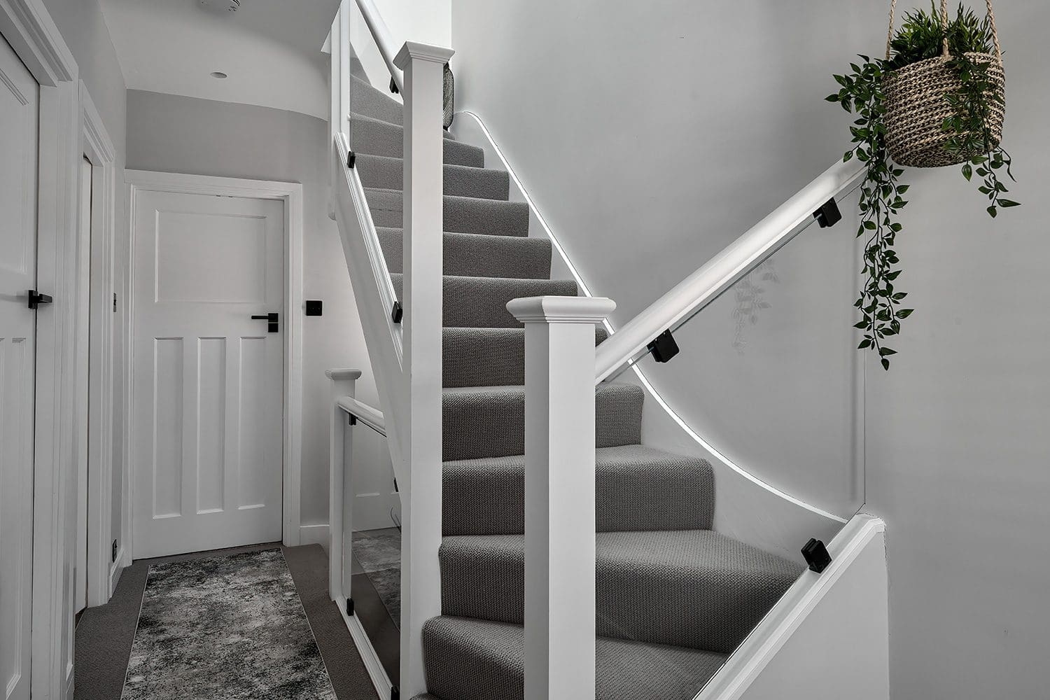 loft conversion staircase ideas - sleek glass staircase of loft conversion