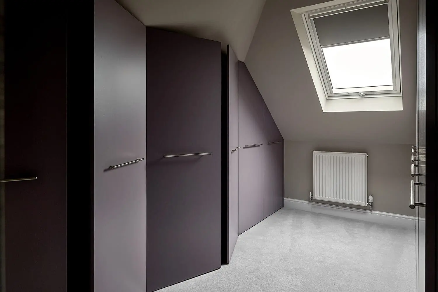 loft dressing room or walk in wardrobe with purple doors